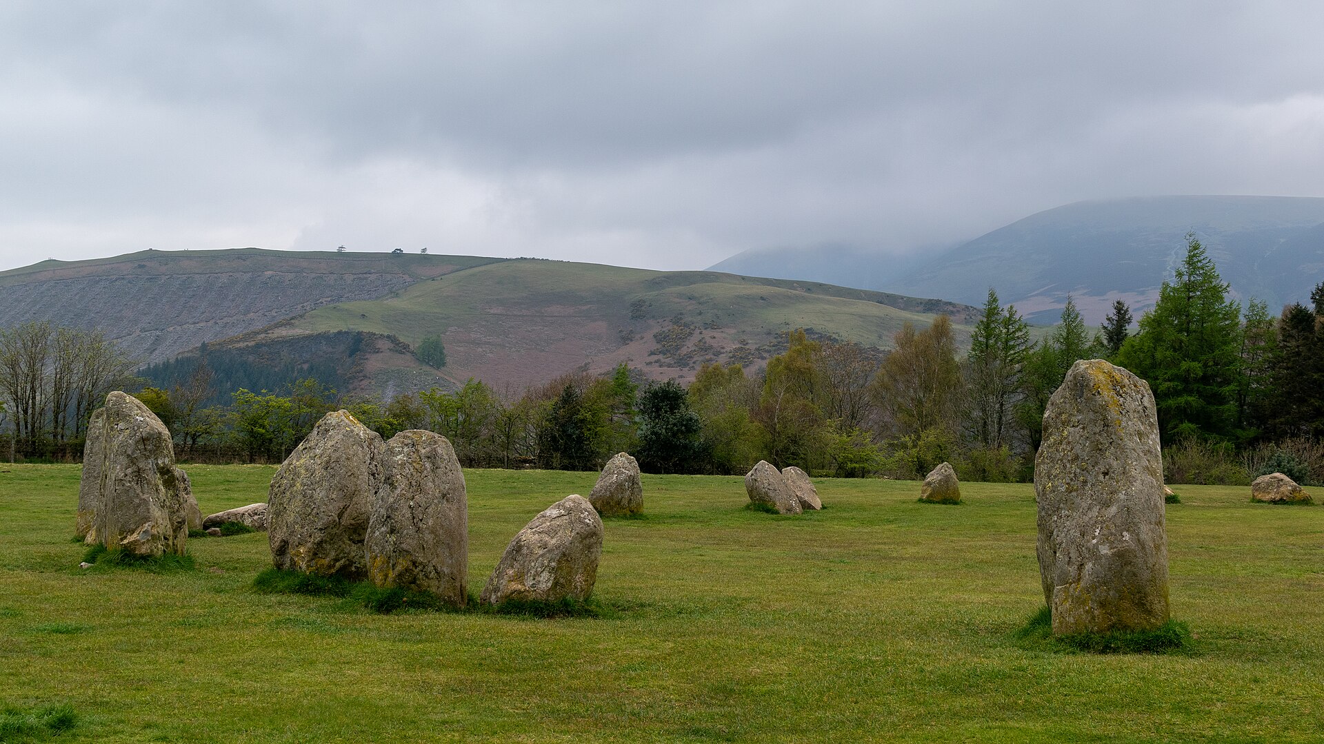 Castlerigg stones on grass with Latrigg and misty fells behind