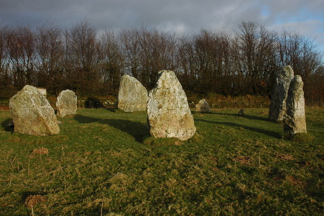 White quartz uprights at Duloe seen across a grassy field
